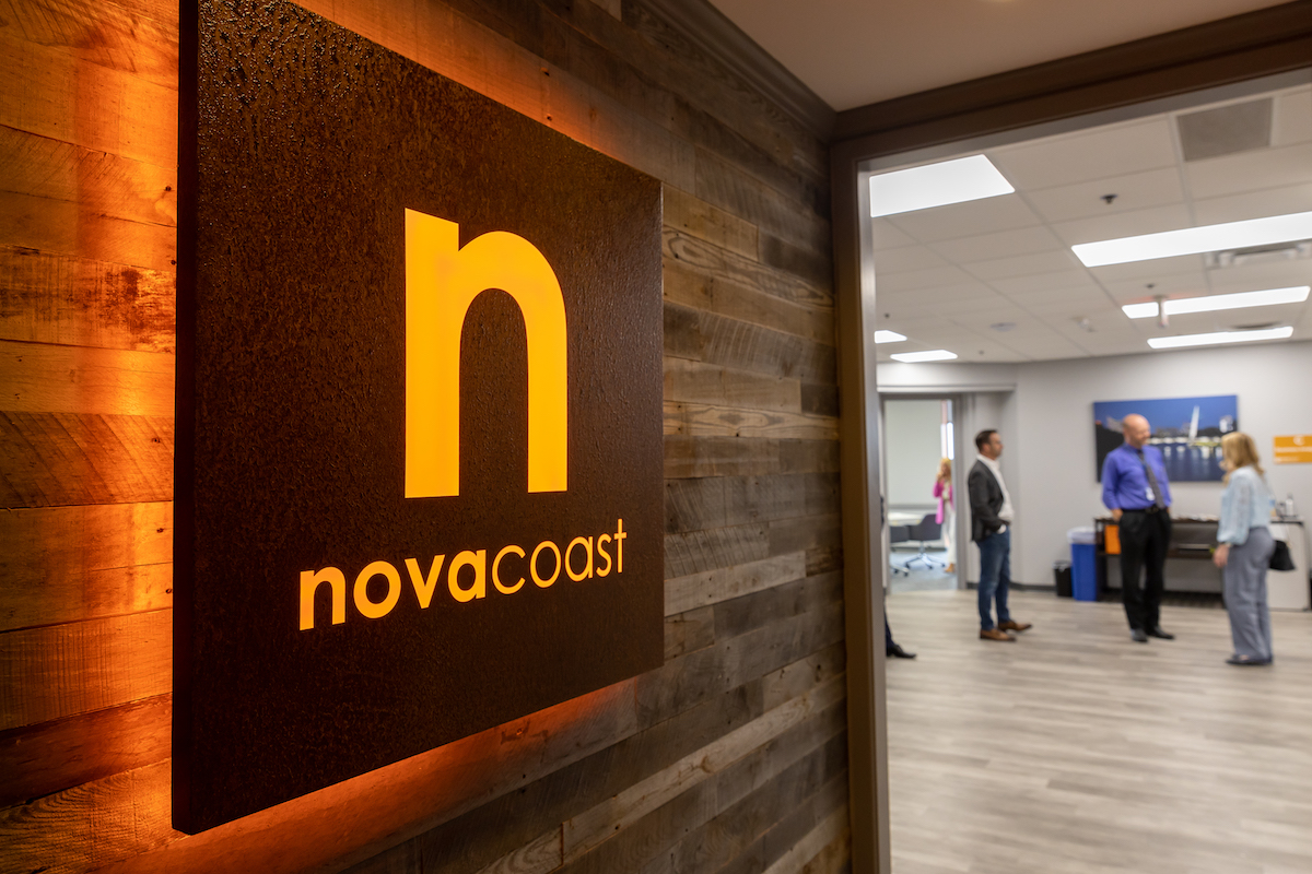 The orange Novacoast sign at the entrance to the Wichita office